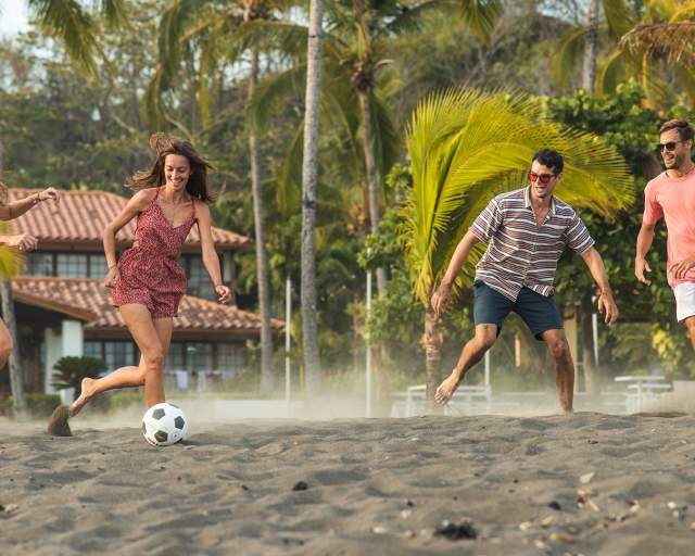 Friends having fun and playing with a ball on Cambutal beach