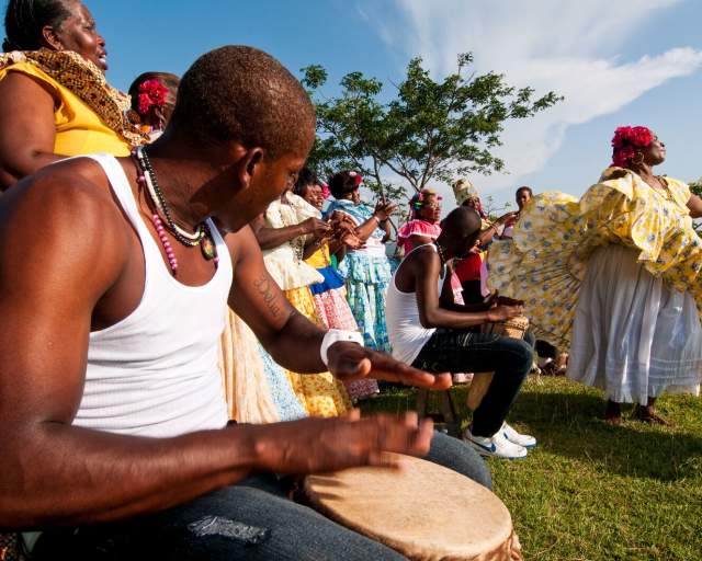 Men playing drums and women performing congo dances spanish colonial fortress.  Colon province, Panama, Central America.
