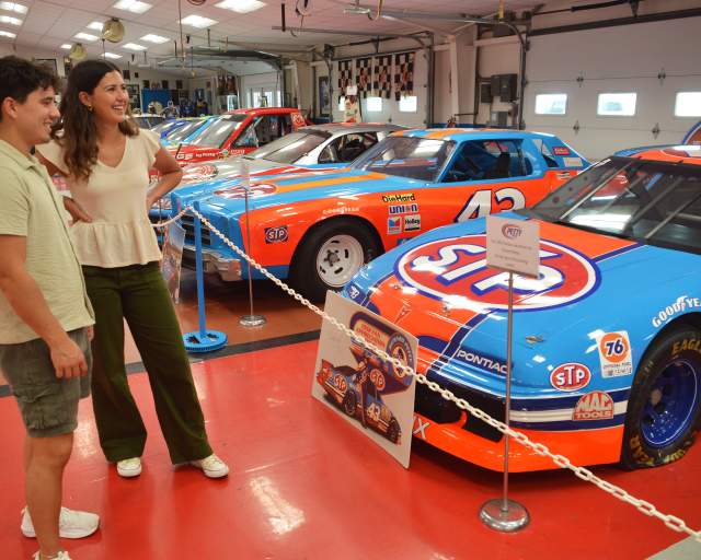 Couple looking at cars on display at the Petty Museum in Randleman, NC
