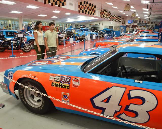 Couple exploring the car collection at the Petty Museum in Randleman, NC