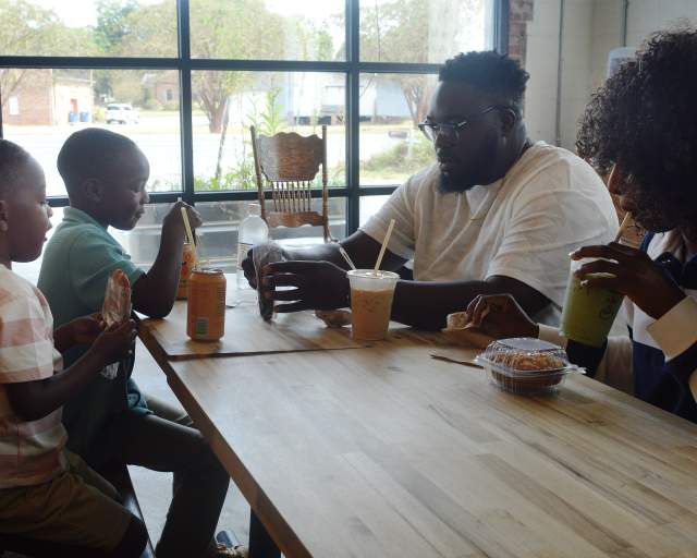 Family enjoying coffee and treats at Seagrove Cafe