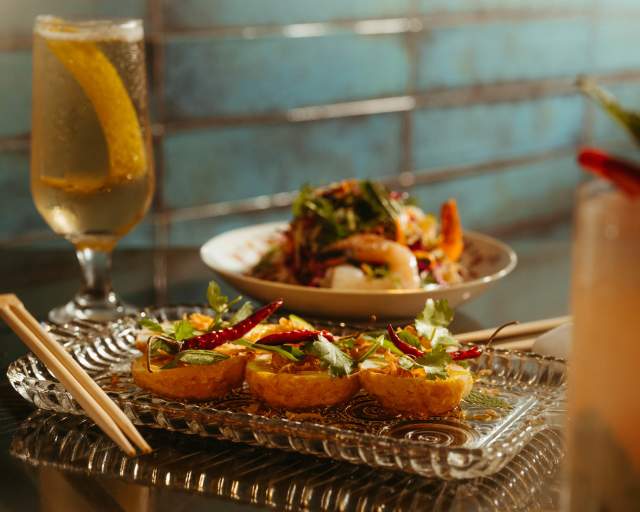 Tokyo Cowboy dinner spread with tall beverage glass