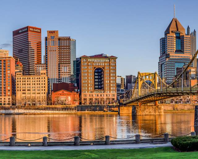 City skyline pf Pittsburgh, Pennsylvania with two yellow bridges showing