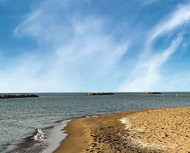 Man seen on the shoreline of Lake Erie on a sunny day