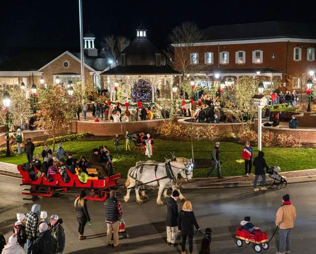 Aerial view of people and horse drawn carriages during the holidays in Ligonier's downtown