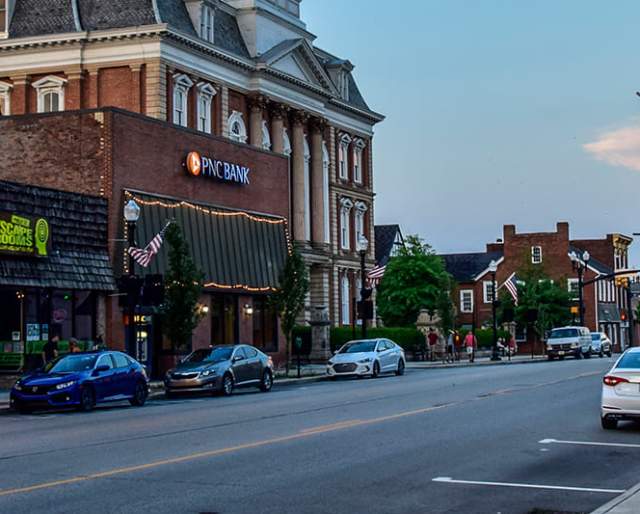 Downtown main street with quaint shops and buildings, and a vibrant, old school movie theater sign that reads Indiana