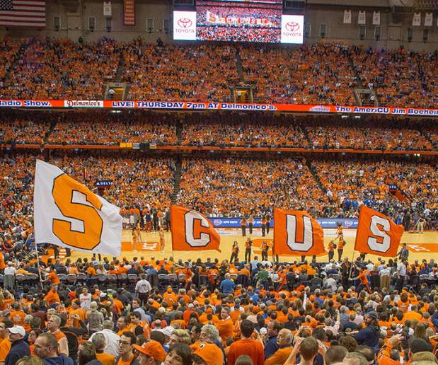 Cheerleaders Show Off "SCUSE" Flags In Front of Syracuse Basketball Fans During Halftime