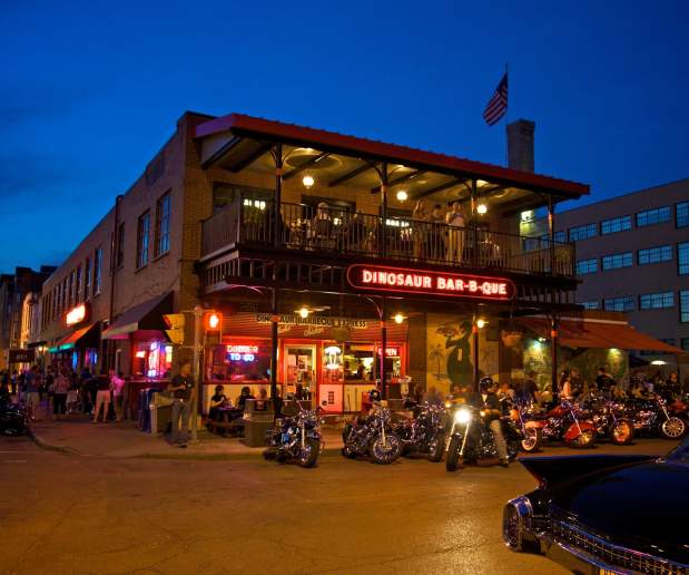 Outside of Dinosaur BBQ at Night with Motorcycles Parked In Front