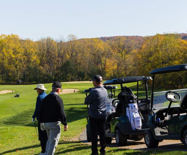 People standing waiting to golf at Green Lakes Golf Course