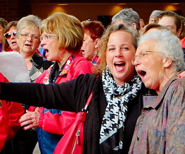 Group of Women Stand Together in Crowd with Mouths Open