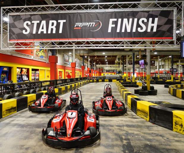 Red Go-Karts racing on an indoor track at destiny usa