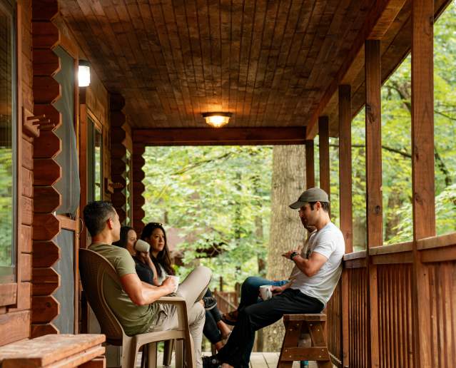 Benner's Meadow Run Campground cabin with people on porch