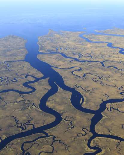 Aerials of the National Wildlife refuge and the seaside town; plus sea-levelshots of the shoreline and an angler in silhouette