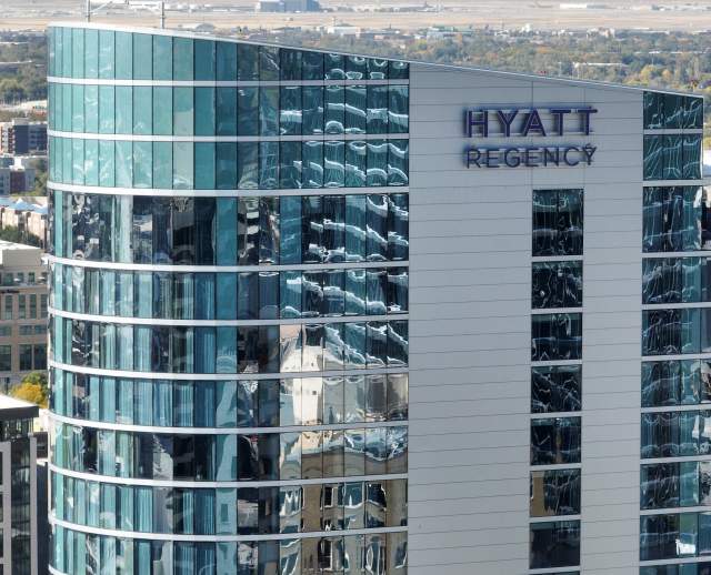 A picture showing the top floors of the Hyatt Regency focused on the sign