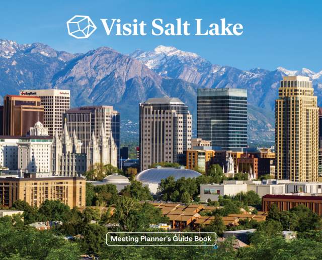Skyline of Salt Lake with trees in the foreground, the temple and skyscrapers, then the Wasatch Mountains in the background