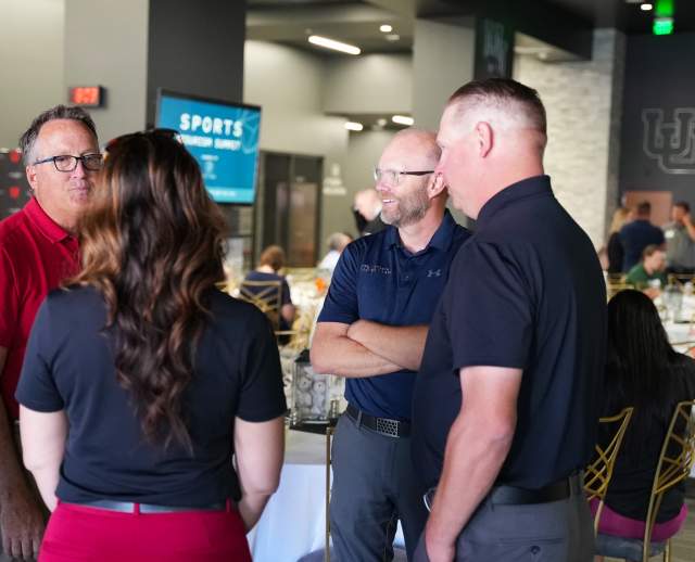 Clay Partain  speaking with a few people