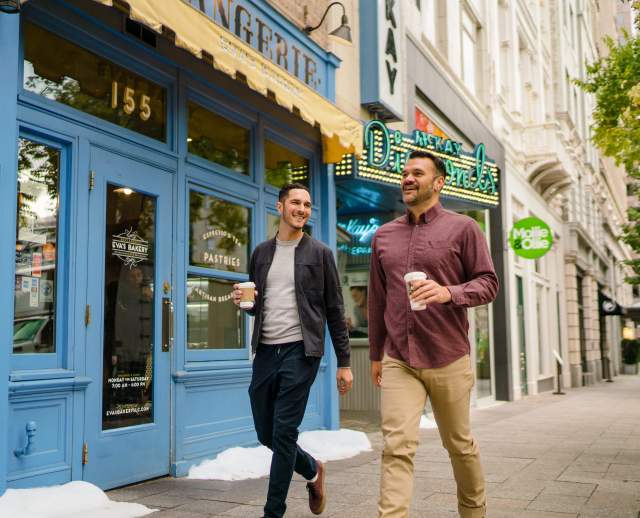 Couple Walking Past Eva's Bakery