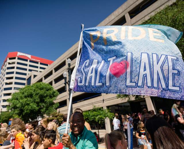 Man holding Pride Salt Lake Flag