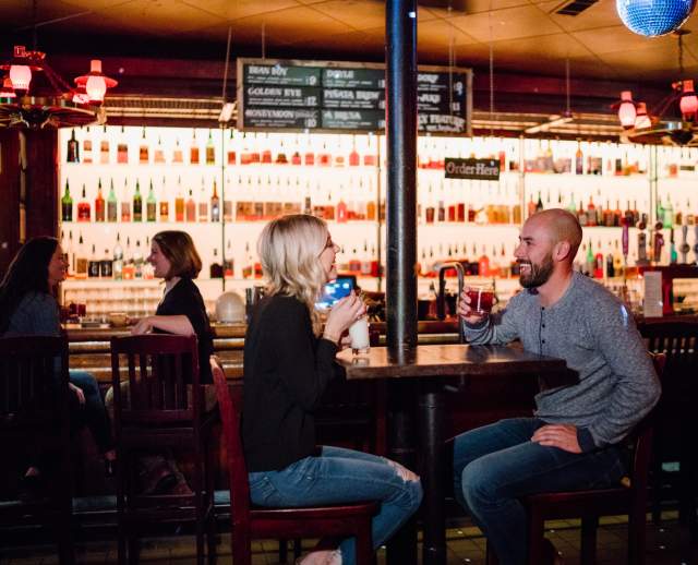 Image of a couple enjoying a cocktail at Bar X together