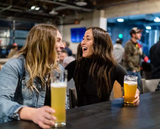 LGBTQ couple drinking at Fisher Brewing