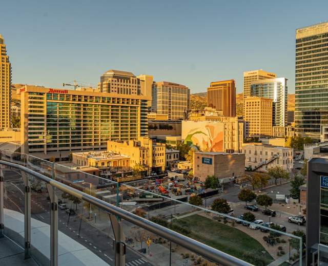 A view of downtown Salt Lake from the 6th floor of the Hyatt Regency. Buildings, one with a mural, bathed in golden light