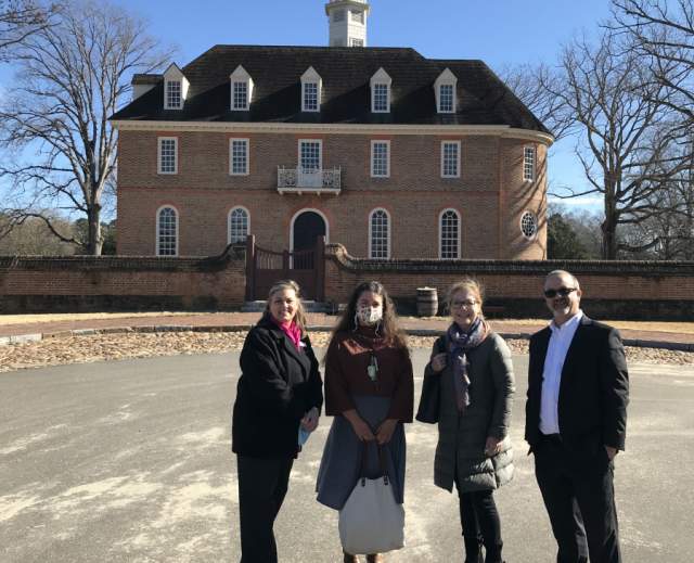 Student and Youth Travel Association posing in front of Capitol building in Williamsburg, VA.