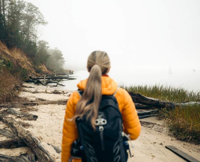 Woman hiking at York River State Park Fossil Beach