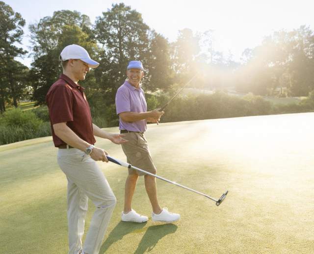 Two Men Golfing at the Golden Horseshow