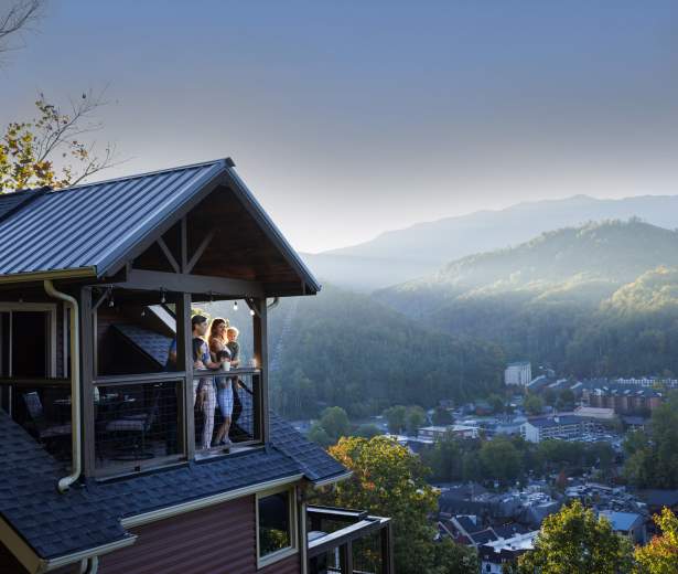 family at cabin balcony