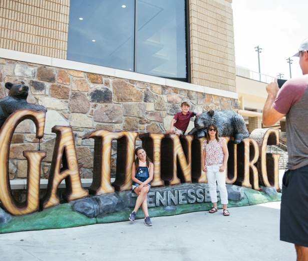 Family in front of Gatlinburg sign