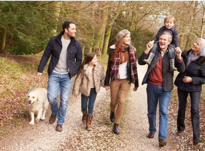 family walking a dog in autumn
