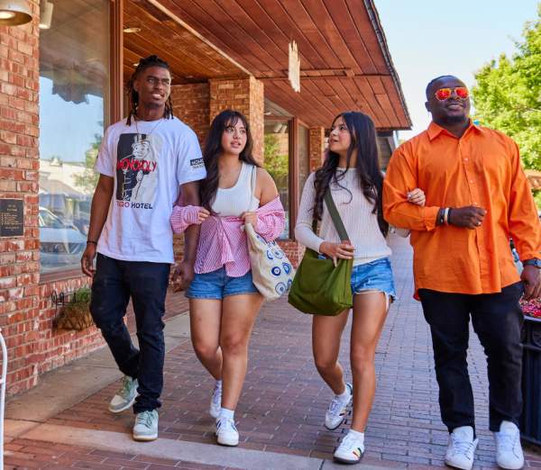a group of friends walking by a shop