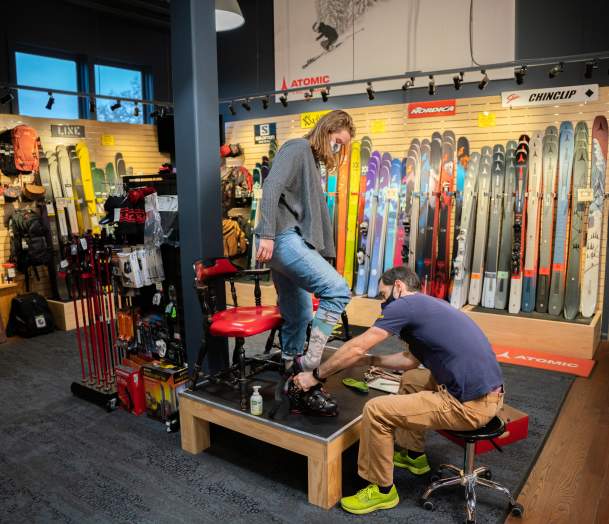 ski boot fitting with many skis behind