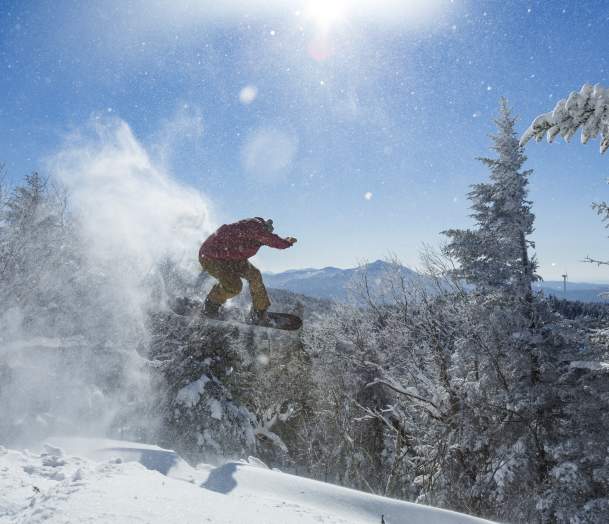 snowboarder shredding the gnar on a sunny winter day