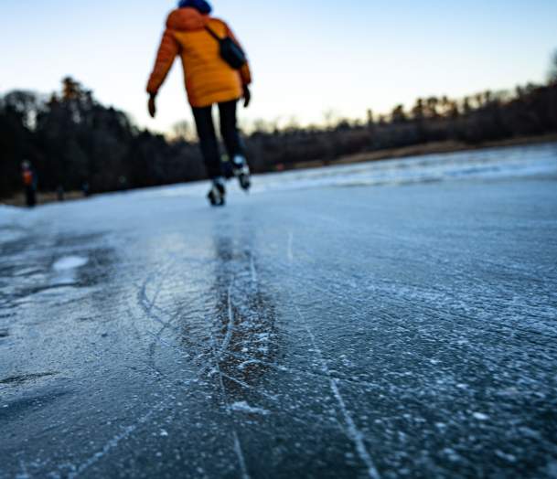 Skater glides across the ice on a winter day in Burlington, Vermont