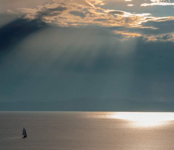 Calm Lake Champlain with solo sailboat