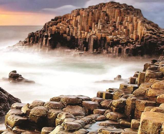 Photo of Giant's causeway scene in Northern Ireland with a pink sky