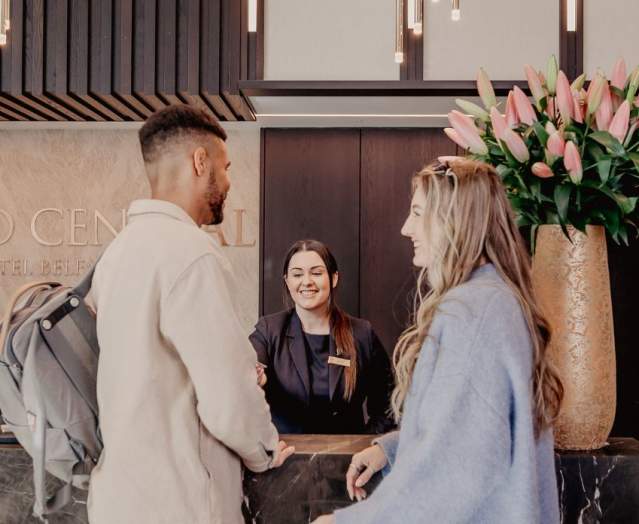 Couple checking into the Grand Central Hotel Belfast