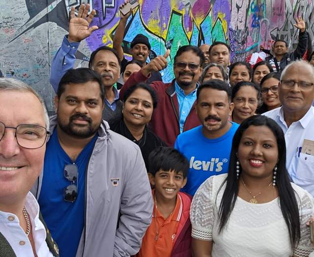 Visitors and tour guide posing for a photograph