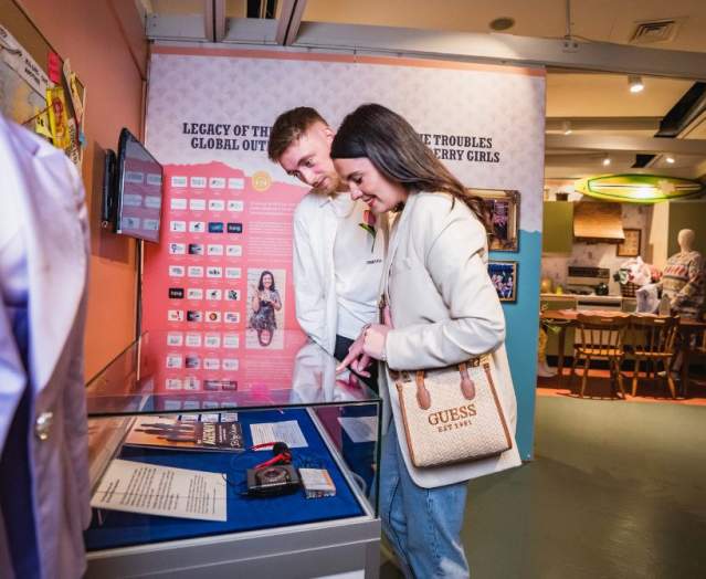 Couple looking at one of the displays for the Derry Girls Experience in The Tower Museum