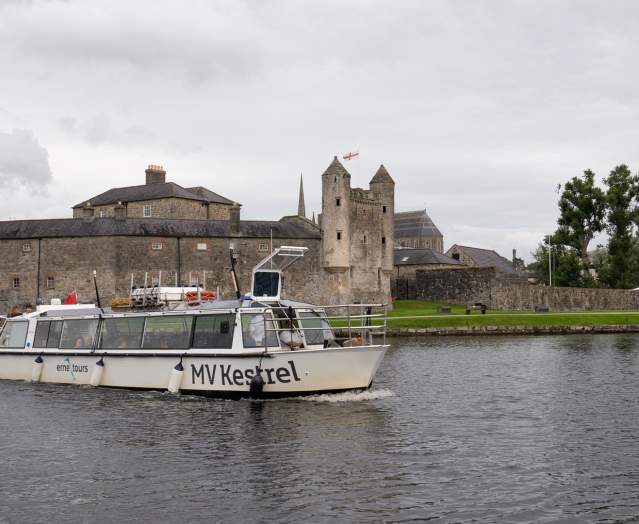 MV Kestrel boat sailing past Enniskillen Castle