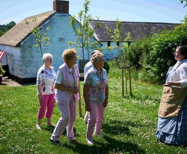 Group of people walking through the garden at Arthur Cottage