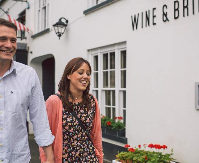 Couple walking outside Wine & Brine restaurant