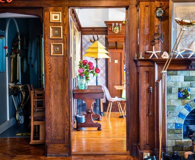 A beautifully decorated hallway can be seen, along with a glimpse of a living room in Cairn Bay Lodge