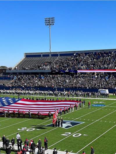 McKinney ISD Stadium during National Anthem with large flag on field