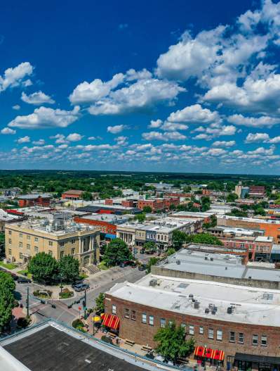 drone shot of downtown McKinney with blue sky and clouds