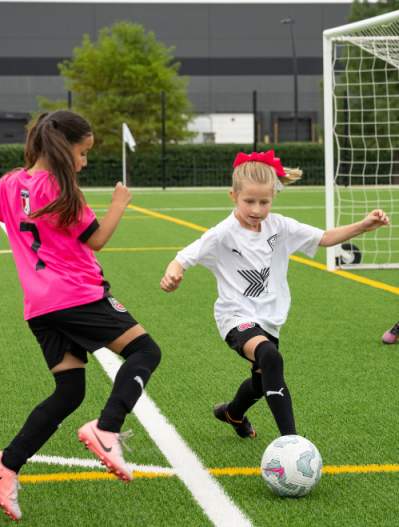 Young kids playing soccer