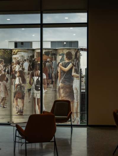 View of the silos outside of city hall from the point of view in the building looking out of a window