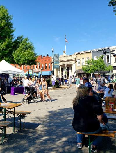 People sitting at tables at Arts in Bloom 2021 in downtown McKinney