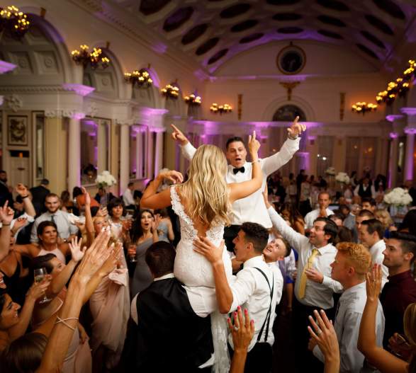 Reception in Hall of Springs with bride and groom on guests' shoulders